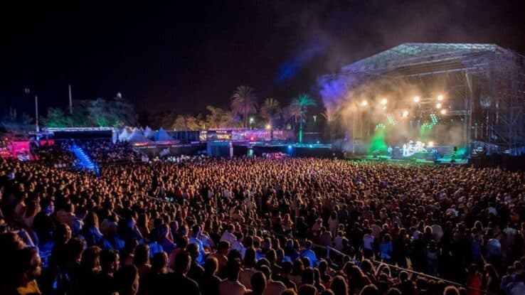 Festival audience facing an illuminated stage